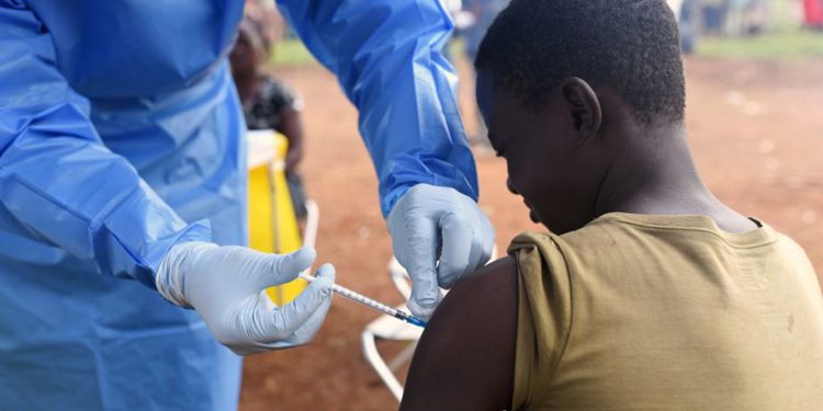 A Congolese health worker administers Ebola vaccine to a boy who had contact with an Ebola sufferer in the village of Mangina in North Kivu province of the Democratic Republic of Congo, August 18, 2018. REUTERS/Olivia Acland