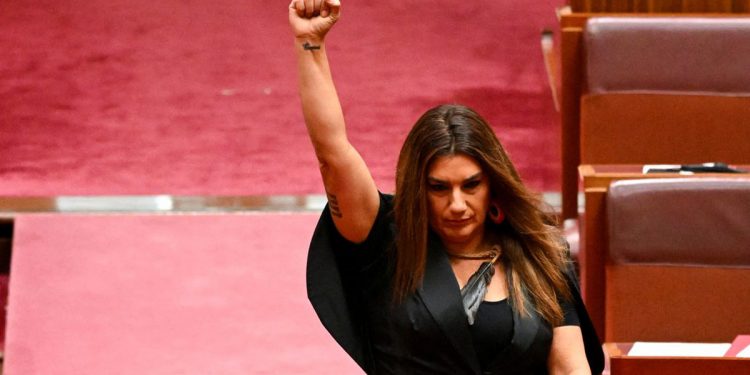 Indigenous Australian parliamentarian Lidia Thorpe raises her fist during her swearing-in ceremony in the Senate chamber at Parliament House in Canberra, Australia, August 1, 2022. AAP Image/Lukas Coch via REUTERS